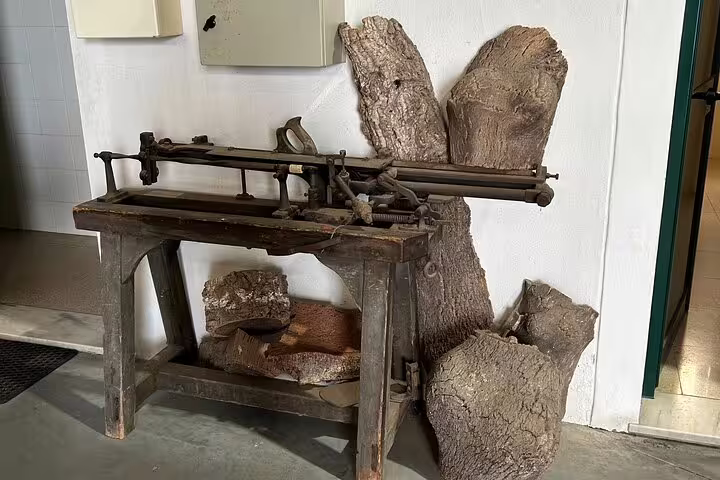 A vintage cork cutting machine displayed at the Cortiza and Herdade Alentejo Factory, highlighting traditional tools.