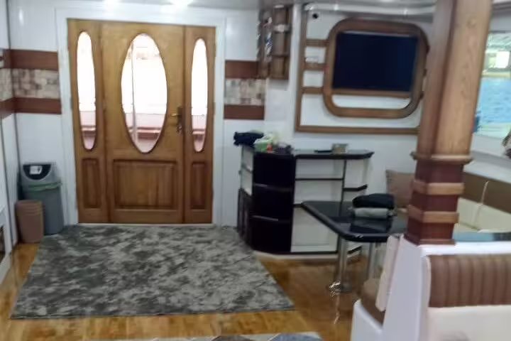 VIP boat interior with wooden doors and bar area for Hamata Island snorkeling tour from Marsa Alam
