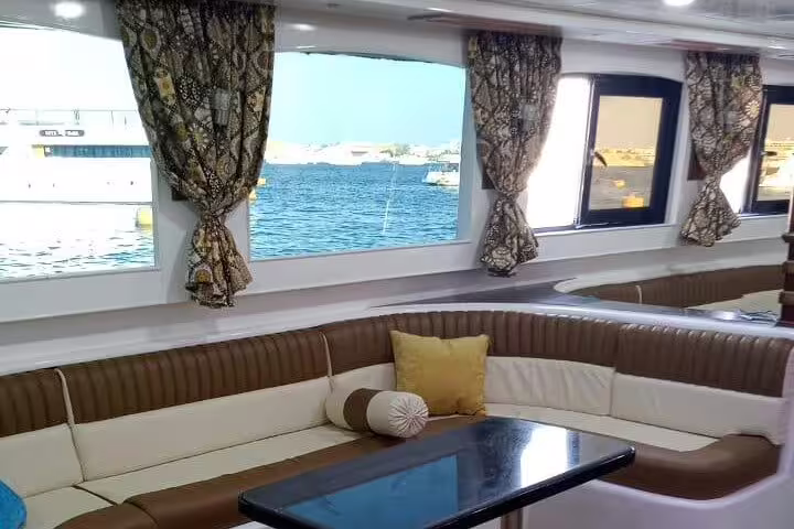 VIP boat lounge with sea-view windows for Samadai Dolphin House snorkeling trip from Marsa Alam