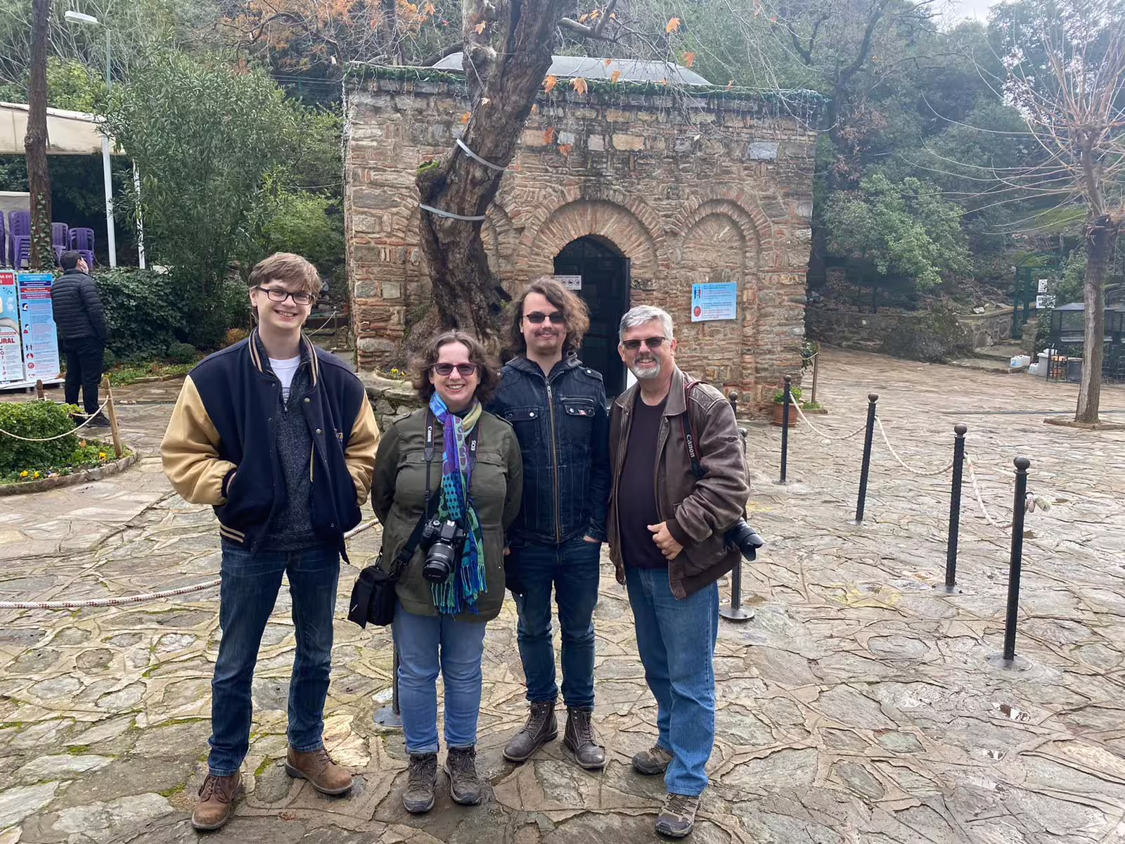 VIP Ephesus shore excursion guests pose by the House of Virgin Mary entrance near Kusadasi port, Turkey