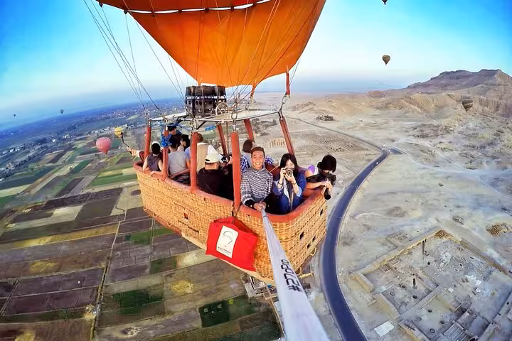VIP Luxor hot air balloon basket selfie over West Bank fields and desert, sunrise tour from all hotels