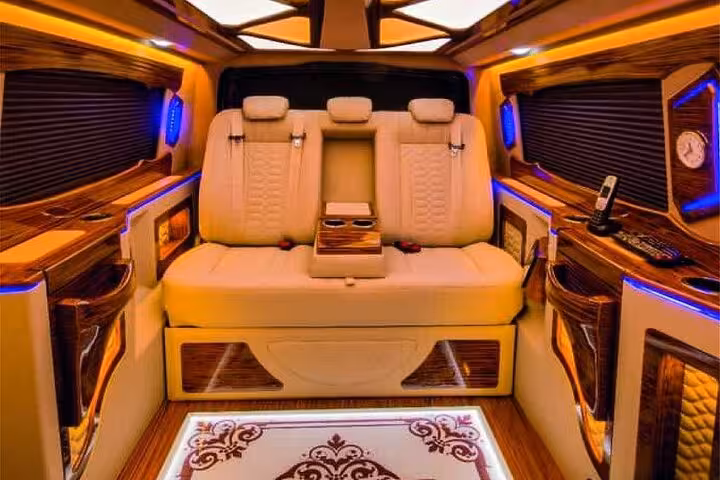 VIP minivan cabin for private Istanbul airport transfer featuring plush seats, wood trim, LED lighting and premium comfort