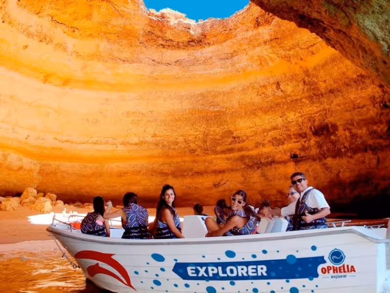 Visitors enjoy a VIP private boat tour inside Benagil Cave, marveling at the cave's natural beauty and vibrant colors.