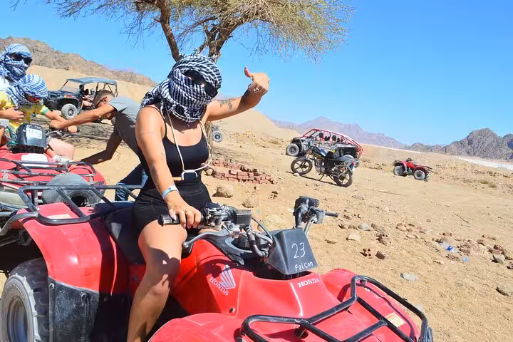 VIP quad bike rider in Sharm El Sheikh desert giving thumbs up on private ATV safari with Sinai views