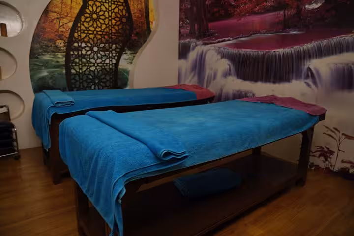 Twin massage beds with blue towels in Sharm El Sheikh spa room, ideal for VIP solo massage experience