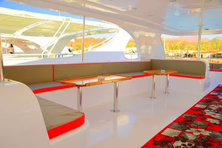 VIP yacht shaded seating area with tables, ideal for Private VIP Boat Snorkeling Day to White Island and Ras Mohamed