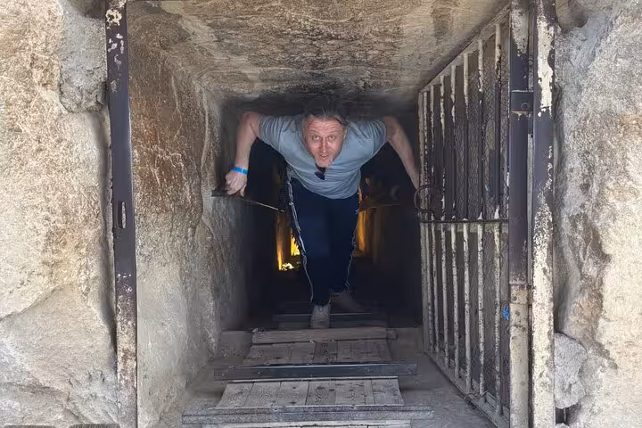 Visitor exiting narrow passage inside Great Pyramid on private Giza Pyramids and Sphinx tour from Cairo