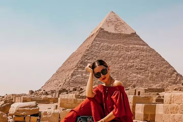 Visitor posing by the Great Pyramid of Giza on a private tour from Port Said, Cairo pyramids excursion