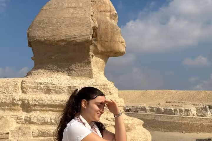 Visitor beside the Great Sphinx of Giza on Grand Egyptian Museum and Giza Pyramids day tour with lunch
