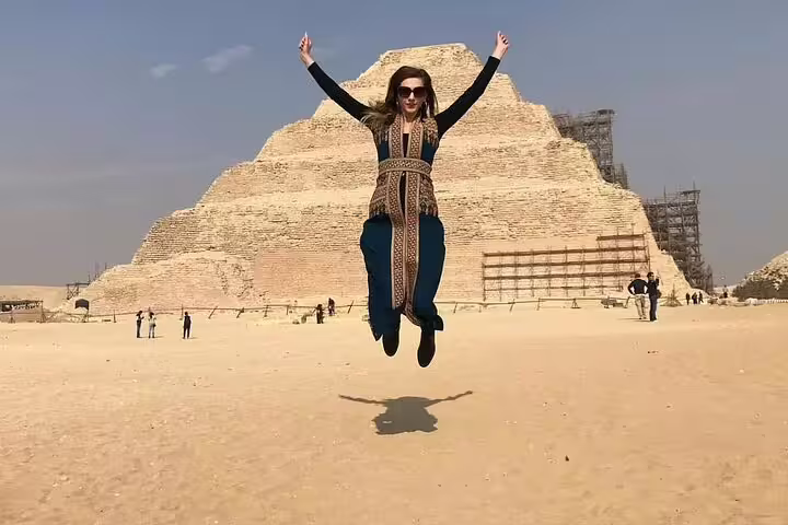 Visitor jumping at Saqqara Step Pyramid on Cairo luxury adventure tour with Memphis, Dahshur and Giza