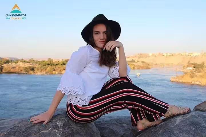 Visitor relaxing by the Nile in Aswan near Philae Temple, ideal for a private guided tour in Egypt