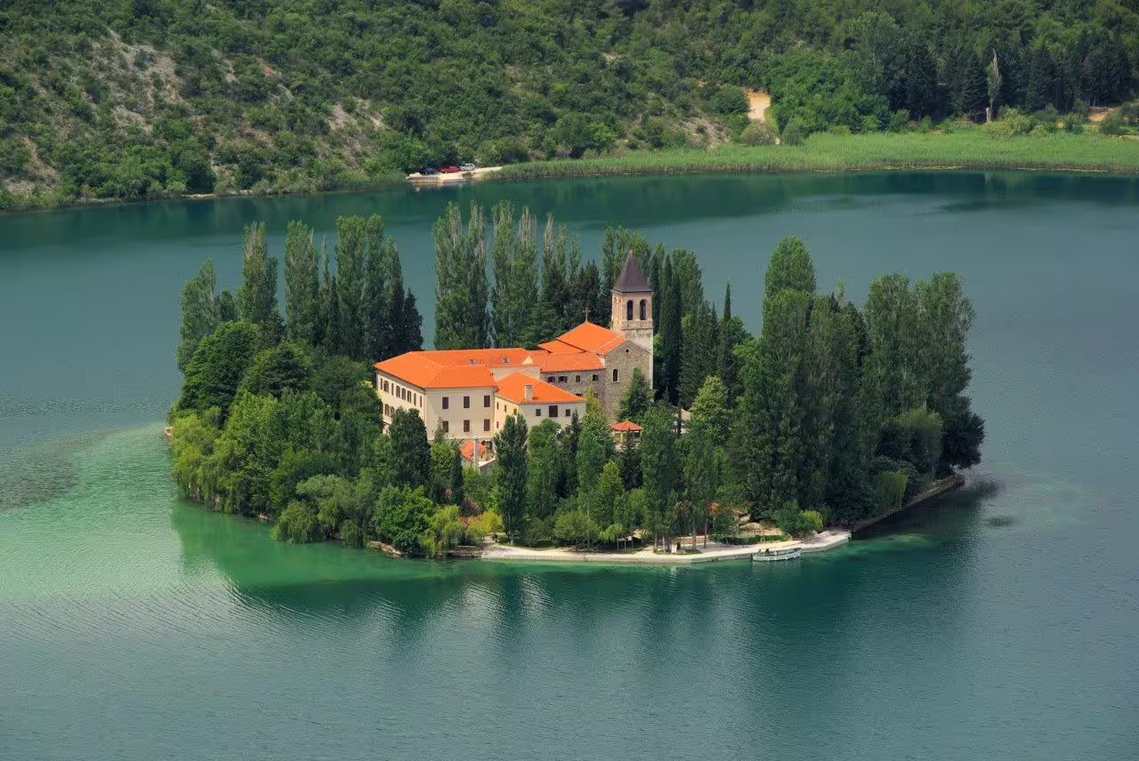 Aerial view of Visovac Monastery on Krka River, scenic stop on Croatia group hiking and food adventure tour