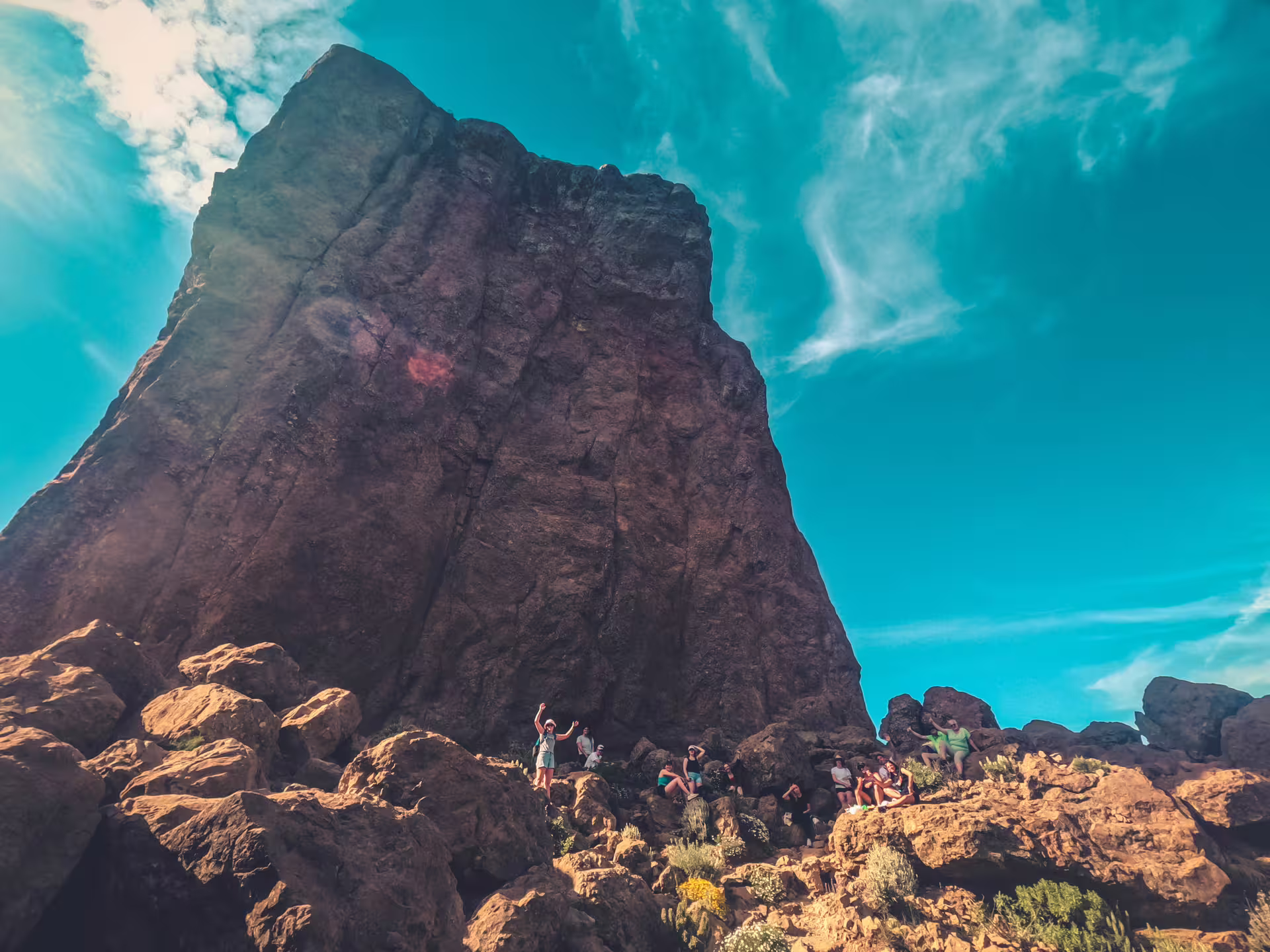 Adventurers exploring rugged volcanic terrain with towering rock formations on the Volcano Heart Tour.