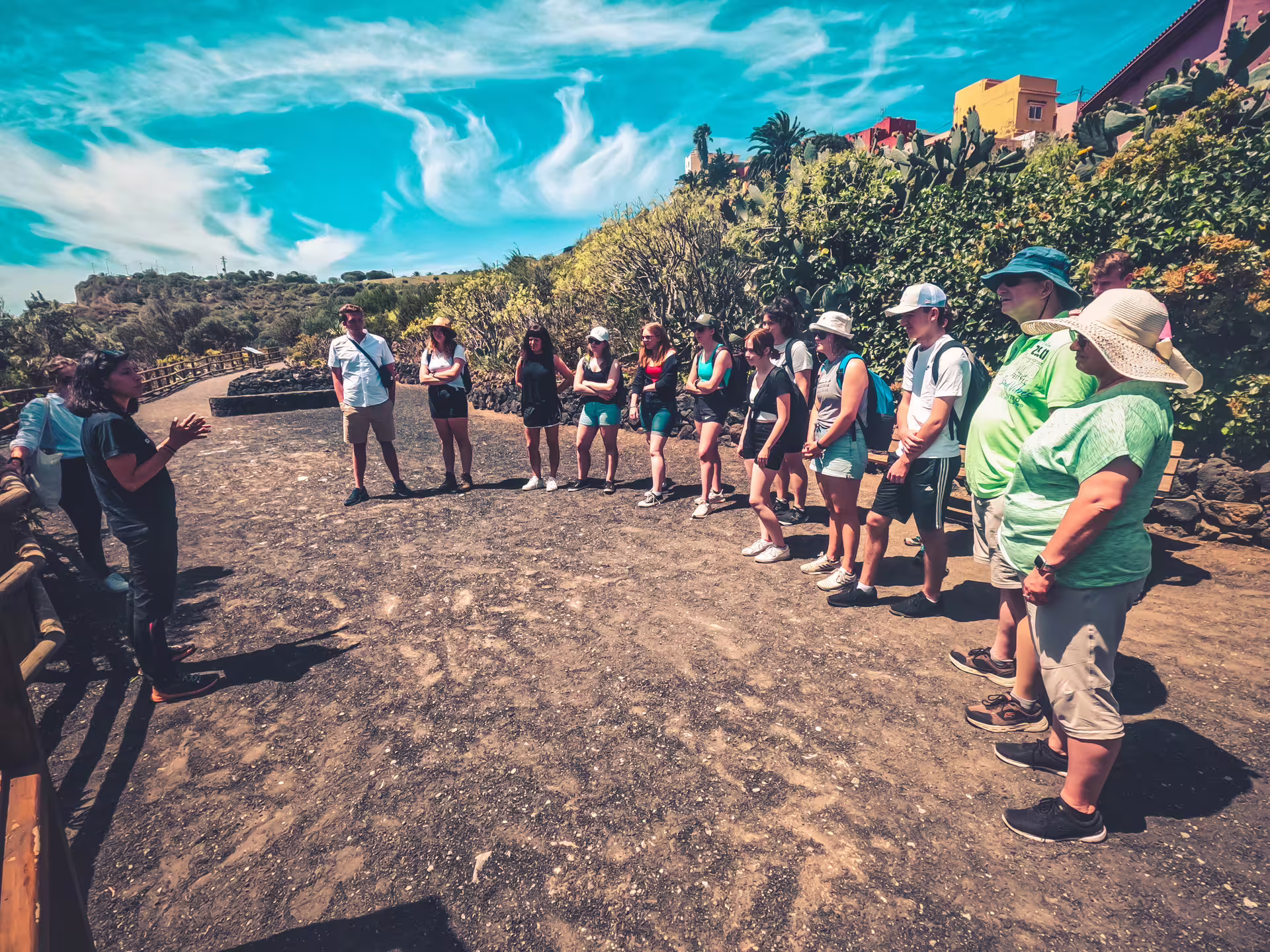 Tour group enjoys sunny day exploring volcanic trails on Volcano Heart Tour with lush greenery and vibrant atmosphere.