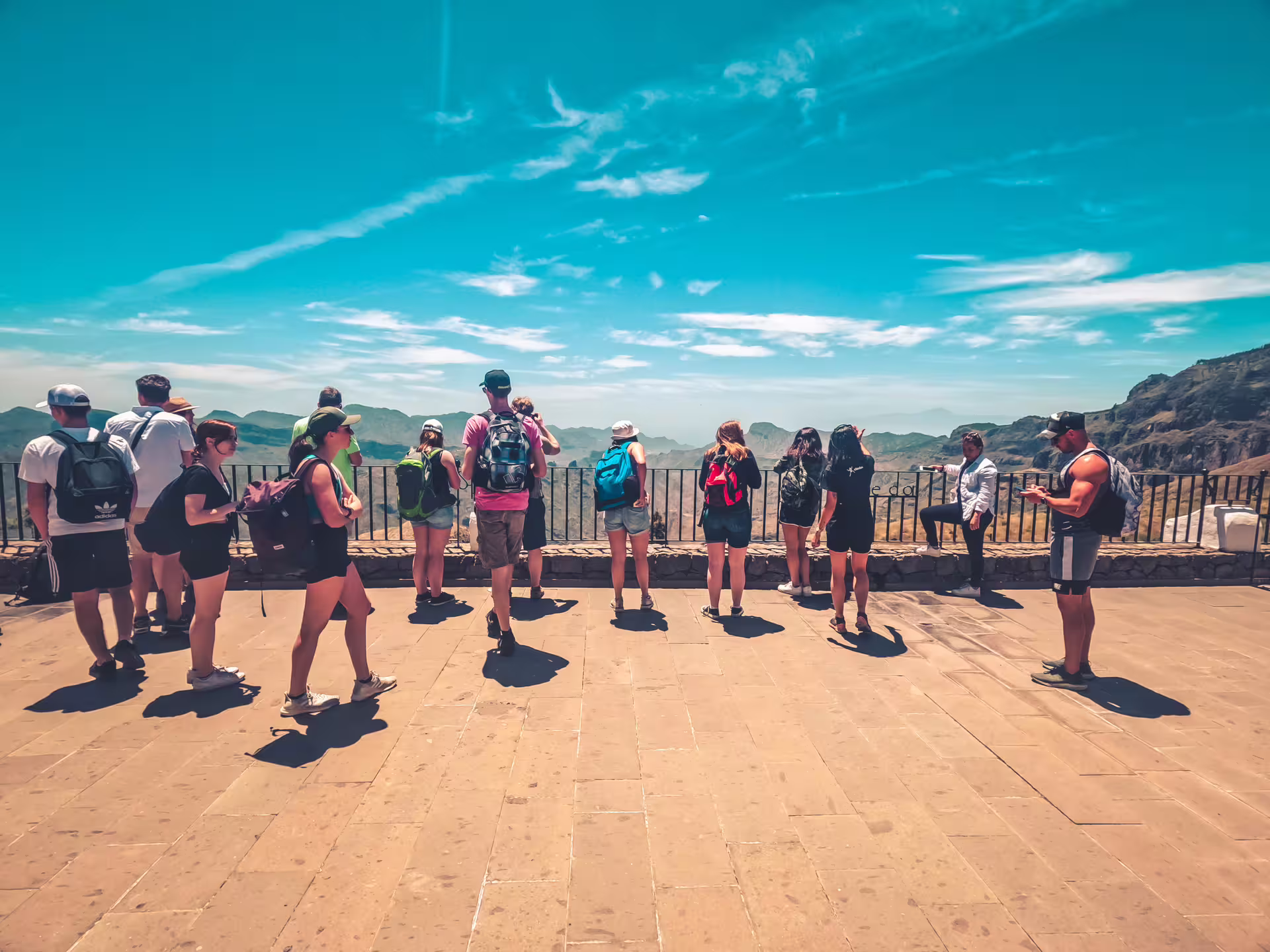 Group of tourists enjoying panoramic views during the Volcano Heart Tour under clear blue skies.