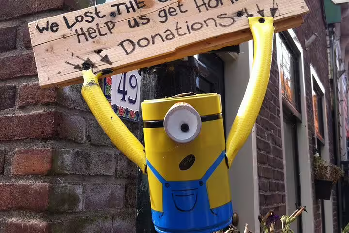 Playful street art in Volendam alley, a fun stop on a private Edam and Volendam walking tour from Amsterdam