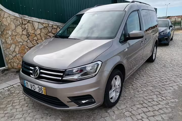 Sleek Volkswagen van parked on a cobblestone street, ideal for private transfers across Faro Albufeira Alvor Seville Lisbon Lagos.