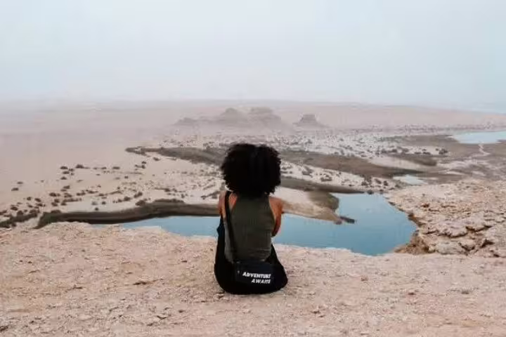 Traveler overlooking Wadi El Rayan desert lakes in El Fayoum Oasis, a highlight of the overnight camping trip from Cairo