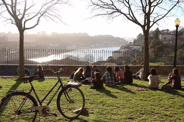 Group enjoying a sunset view over Porto's scenic river, an ideal moment in the walking sunset tour.