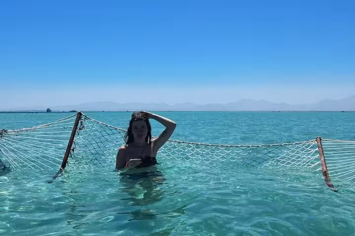 Floating water hammock on Hula Hula Paradise Island sea trip Hurghada, calm Red Sea lagoon view