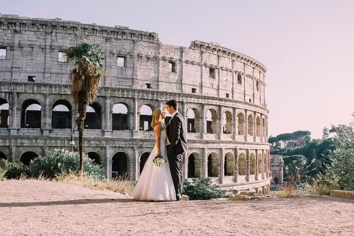 Wedding couple kissing with the Colosseum backdrop, shot during a private personal Rome travel photographer tour