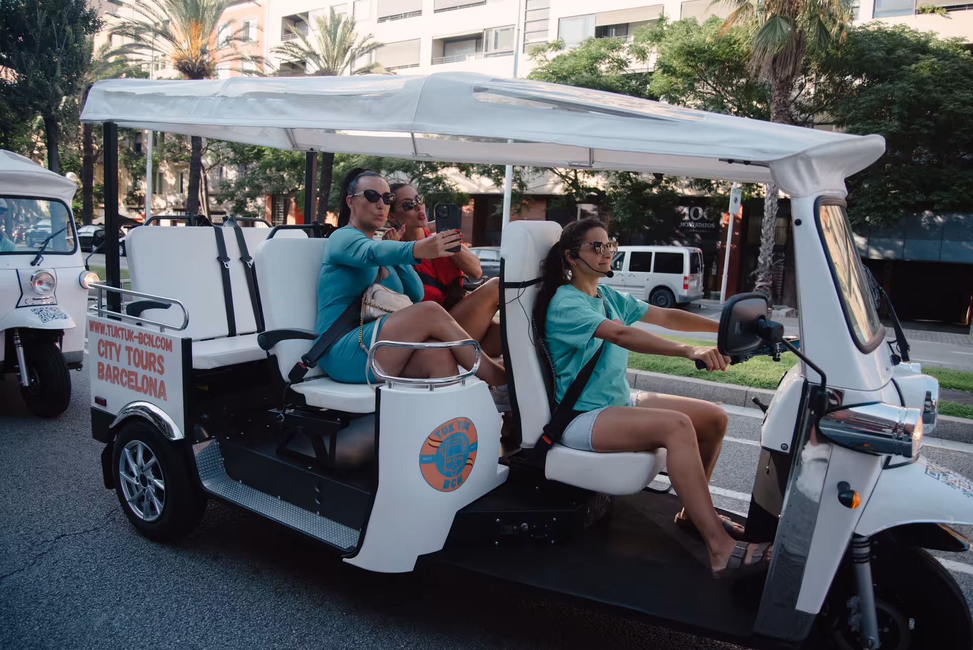 Guests ride an electric tuk tuk on the Welcome Tour Barcelona, sightseeing with a local guide in the city center