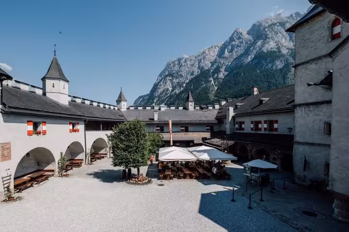 Werfen Castle courtyard with alpine peaks, scenic stop on Eagles Nest and Werfen Castle private day tour