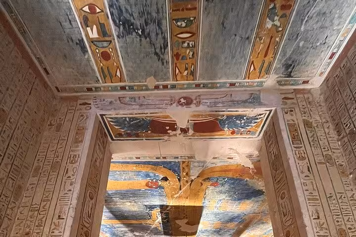 Intricately decorated tomb ceiling with vibrant hieroglyphics on the West Bank Luxor tour.