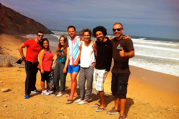 Group of tourists enjoying a sunny day on the beach during the West Coast Natural Park 4x4 half-day tour.