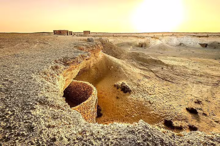 Experience the stunning sunset view over the Mushroom Rock Formation and Zekreet's rugged terrain on the West Coast tour.