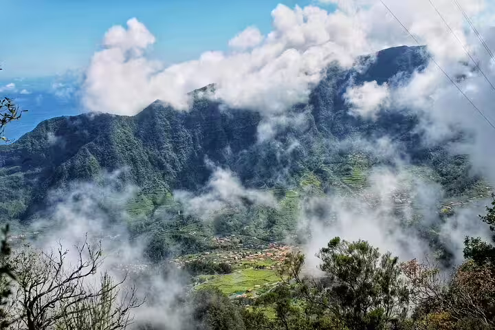 Scenic view of lush mountains and clouds in West Madeira, captured during a full-day private 4x4 tour with a local guide.