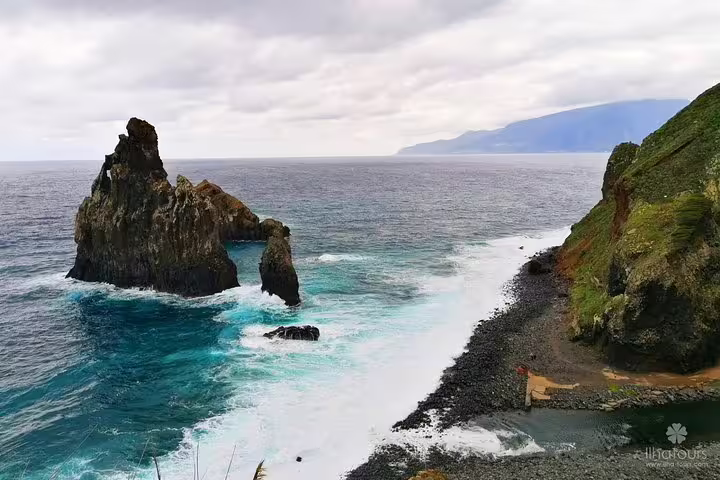 Dramatic coastal rock formations and waves crashing on Madeira's shore, showcasing the island's natural beauty.