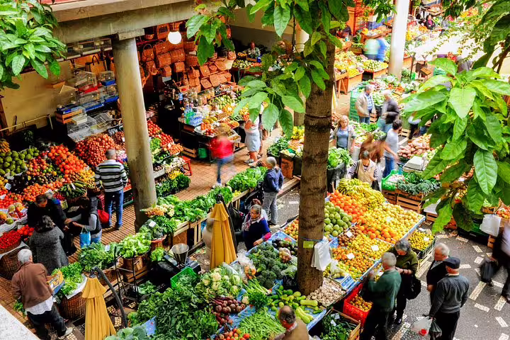 Vibrant market scene in Madeira with diverse fruits and vegetables, highlighting local culture and fresh produce.