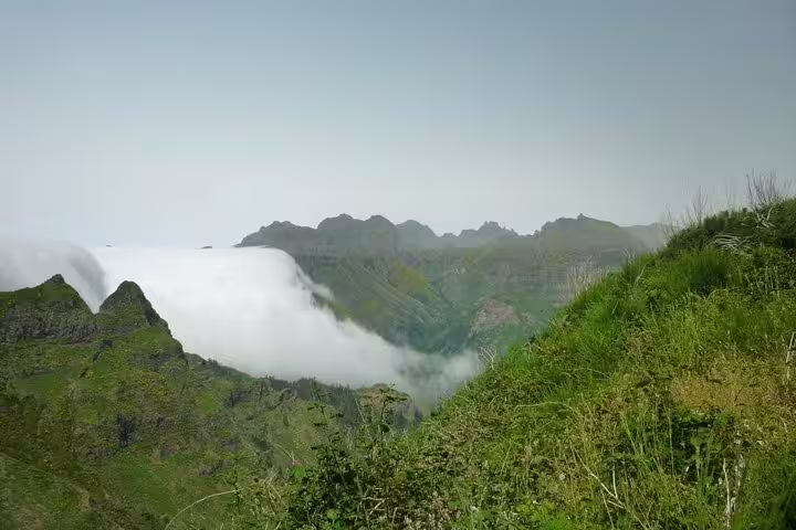 Majestic mountains with rolling clouds in Madeira, offering breathtaking views on the West Tour.