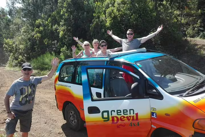 Group enjoying a thrilling 4x4 adventure with Green Devil Tours, surrounded by lush forest scenery.