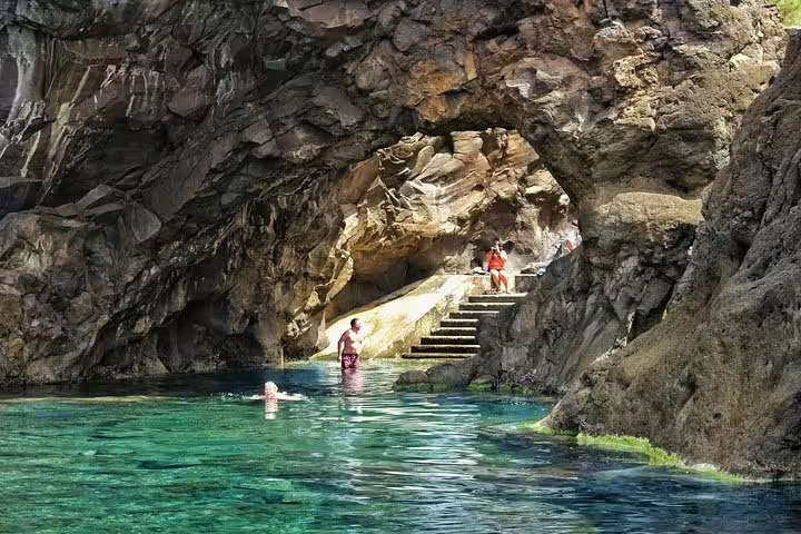 Explore stunning volcanic pools with clear turquoise water and rocky formations on the West volcanic pools tour.