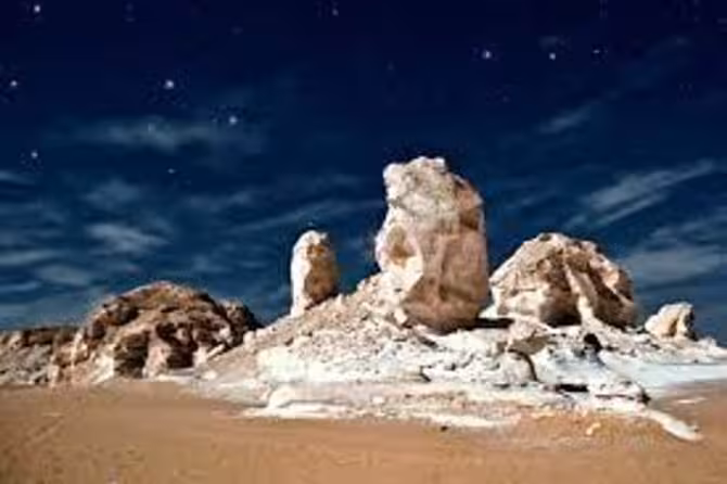 White Desert chalk rock formations under starry sky on 2-day Bahariya Oasis desert tour from Cairo