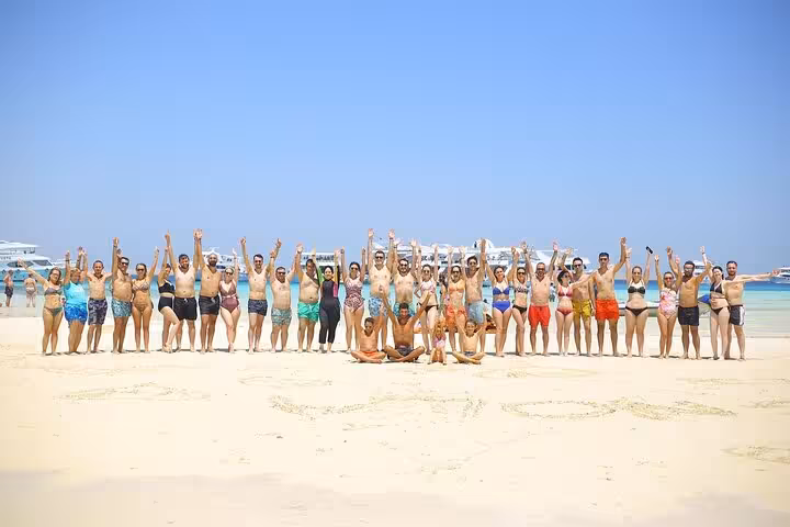 Group photo on White Island sandbar during Ras Mohamed National Park snorkeling tour from Sharm El Sheikh