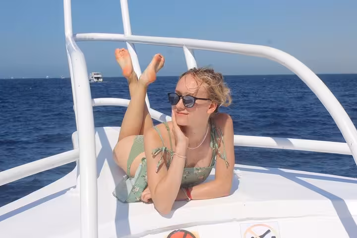 Aerial view of group snorkeling in crystal-clear Red Sea water on White Island and Ras Mohamed tour Sharm