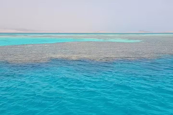 Turquoise Red Sea shallows at White Island on VIP boat snorkeling day trip from Sharm El Sheikh