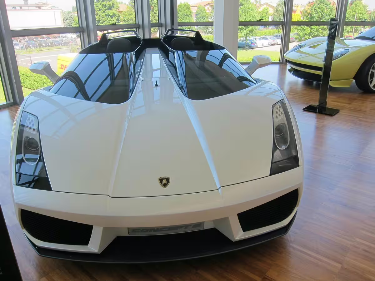 Sleek white Lamborghini concept car displayed in the Lamborghini Museum, ideal for Bologna factory tour enthusiasts.