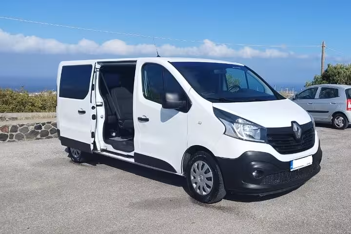 White passenger van with sliding door open for private chauffeur transfer and airport pickup service