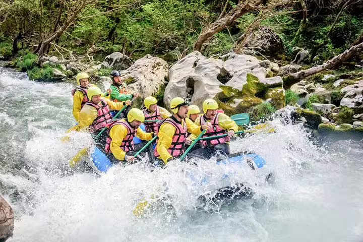 White-water rafting on Lousios and Alfeios rivers in Greece, group paddling through rapids in a canyon
