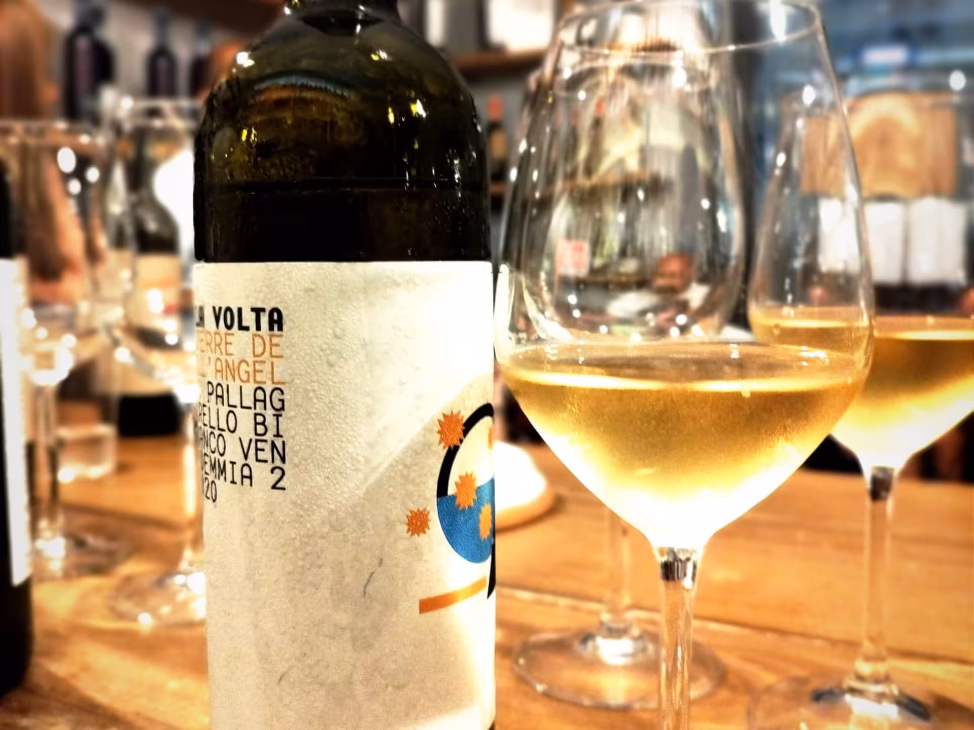 Close-up of a chilled white wine bottle and glasses in a Naples wine tasting tour with local food pairings.