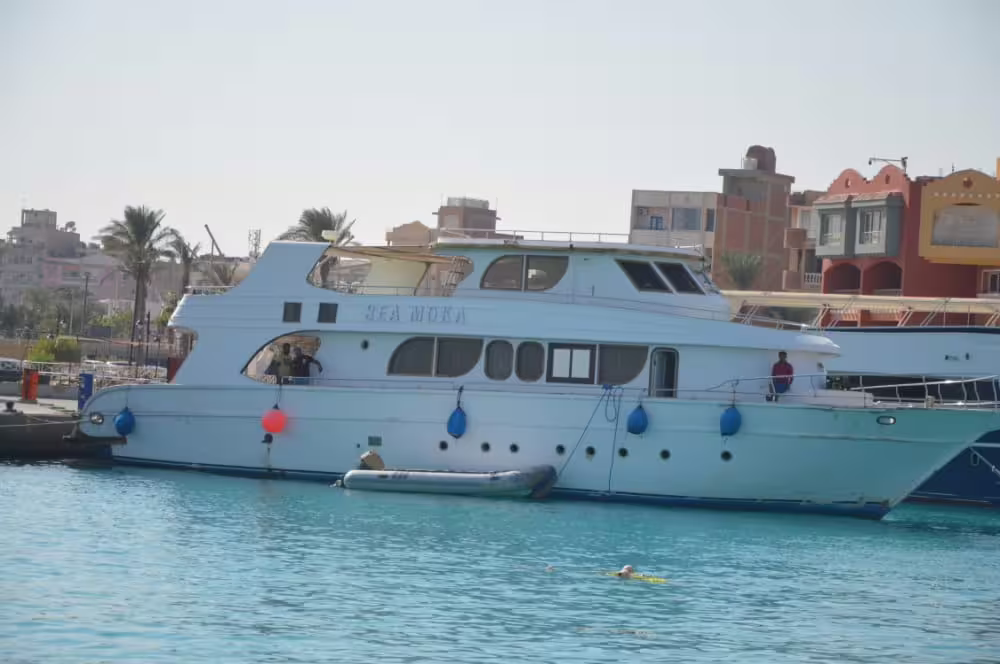 White yacht in Hurghada marina for Orange Bay Island excursion, Red Sea boat trip with snorkeling stops