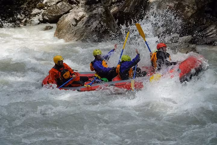 Adventurers navigate thrilling rapids during the Whitewater Action Rafting Experience in Engadin.
