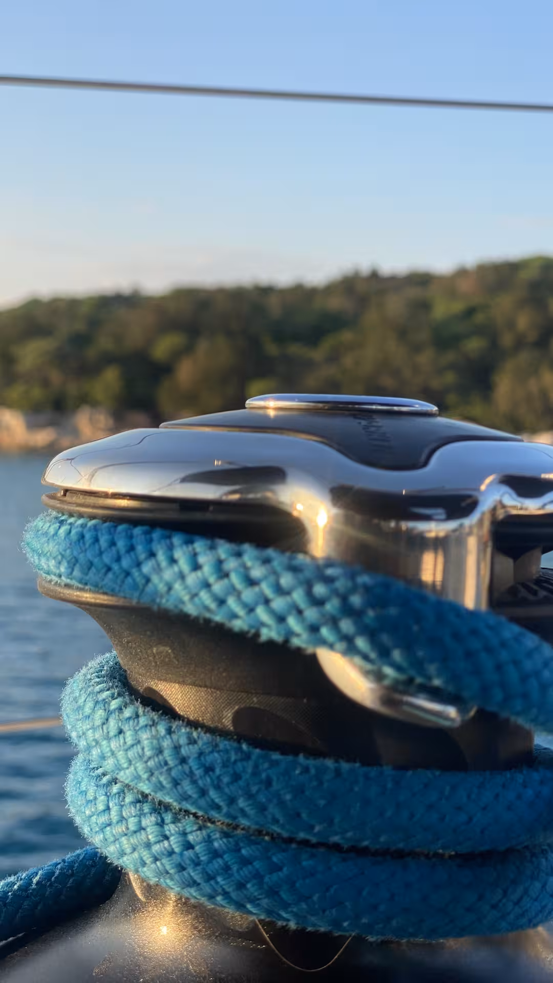 Close-up of winch with blue rope at sunset, practical Zero to Hero sailing skills and boat handling