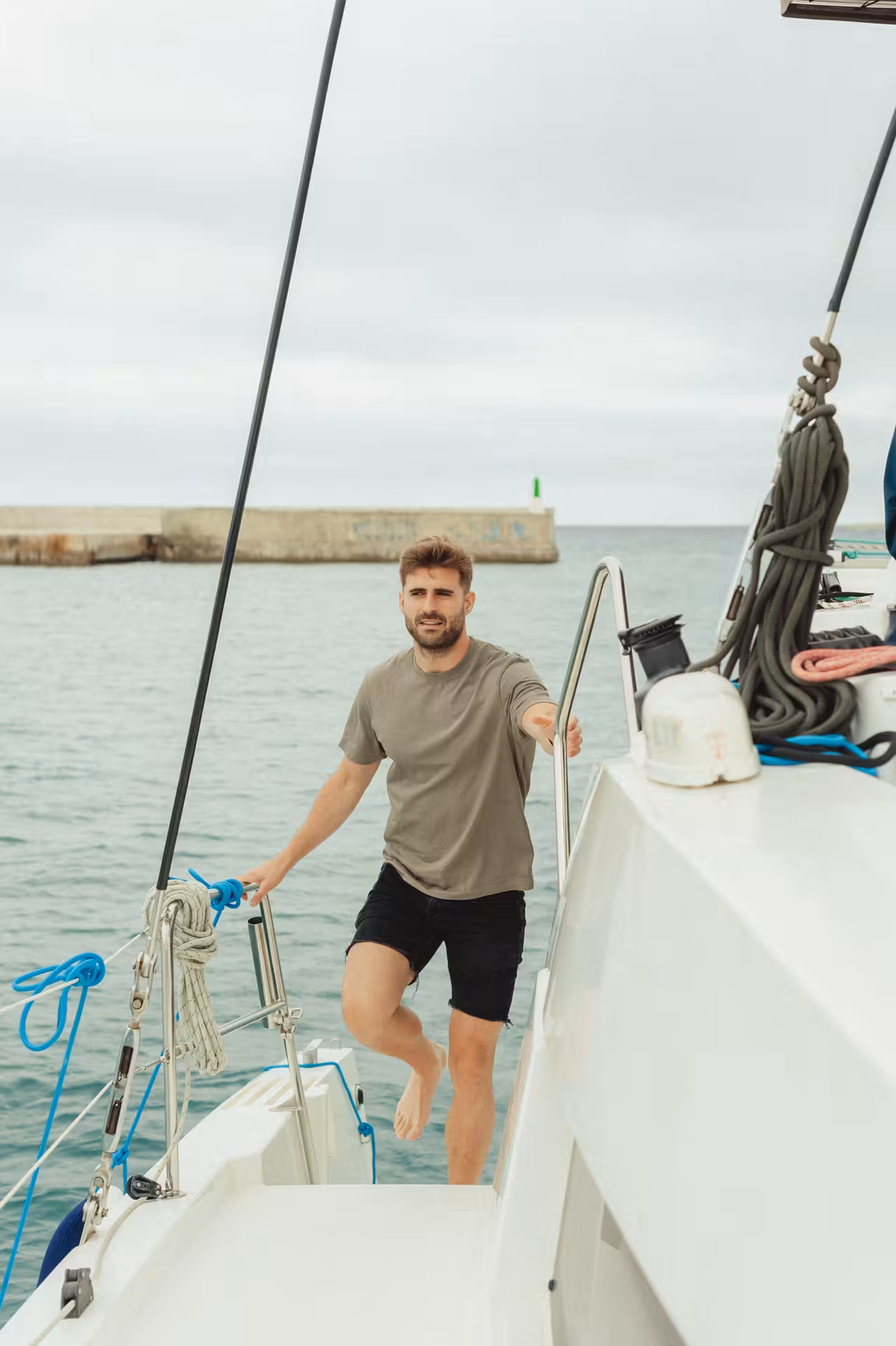Guest boarding a sailboat by the marina, perfect add-on for a Wine & Art coastal experience day trip