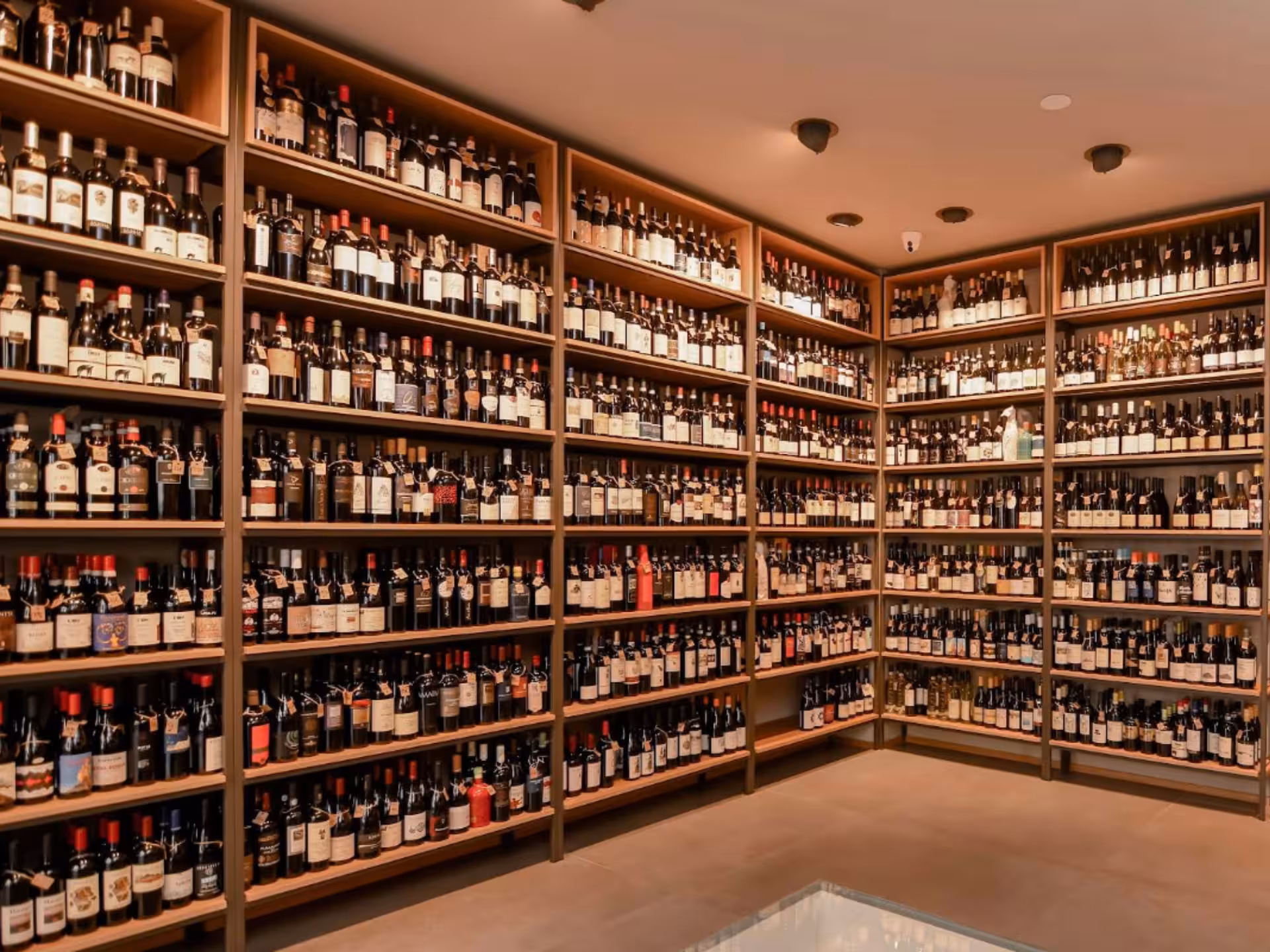 Extensive wine collection displayed on shelves in Bari City Center wine tasting venue.