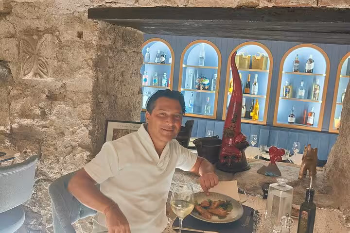 A person enjoying a wine and food pairing experience in a rustic Roman cellar, perfect for a mini sommelier course.